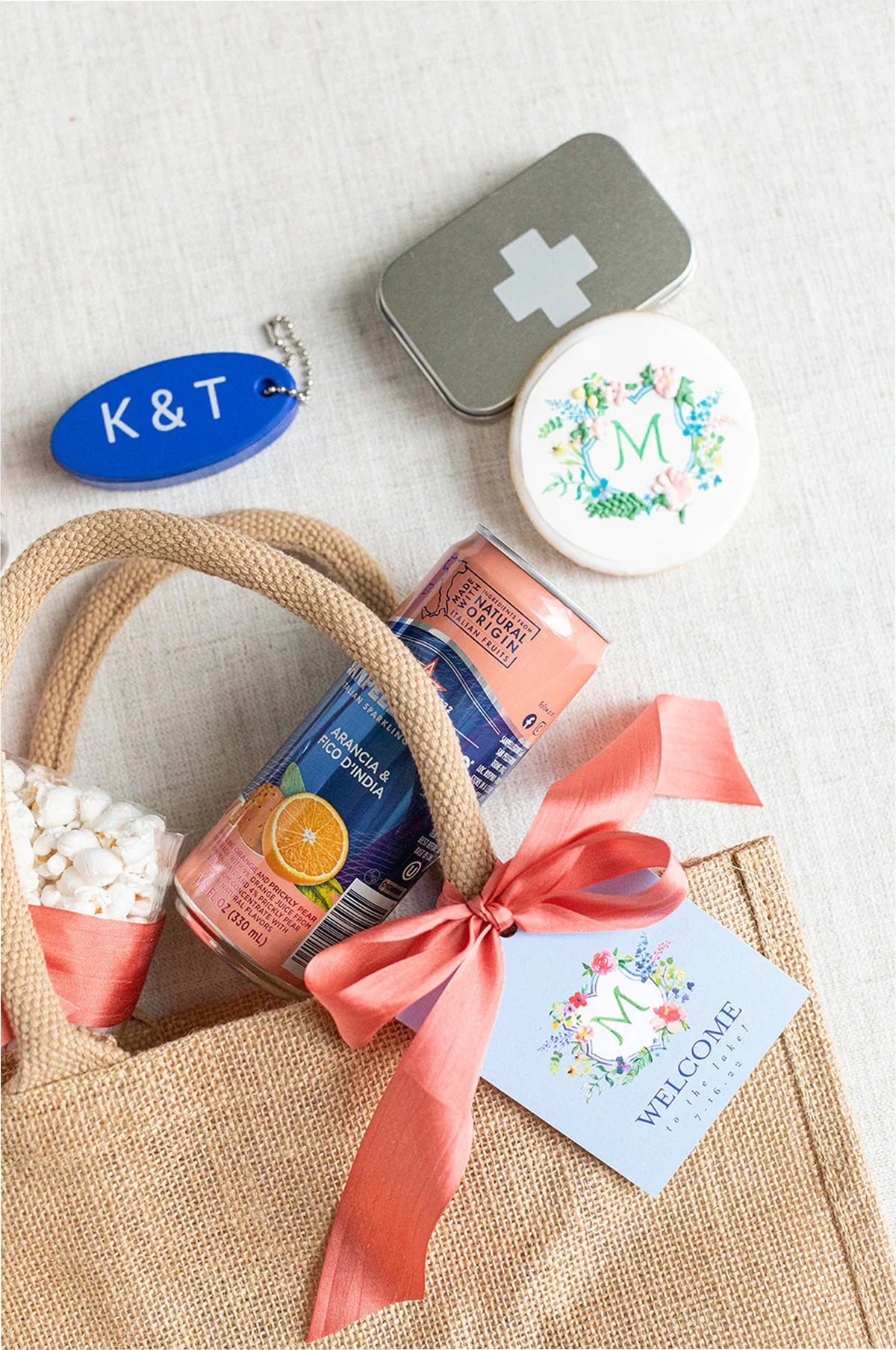 Gift basket with snacks, a first aid kit, and decorative items on a light background